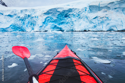 extreme adventure sport, Antarctica kayaking, paddling on kayak between antarctic icebergs, winter leisure outdoors activity