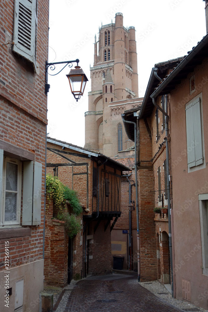 Fototapeta premium Albi street in a rainy day with the cathedral at the background