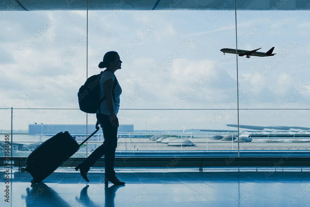 © Song_about_summer - airport travel, silhouette of people at international departure terminal, flight © Song_about_summer - airport travel, silhouette of people at international departure terminal, flight