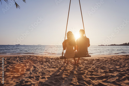 Fototapeta beach holidays for romantic young couple, honeymoon vacations, silhouettes of ma