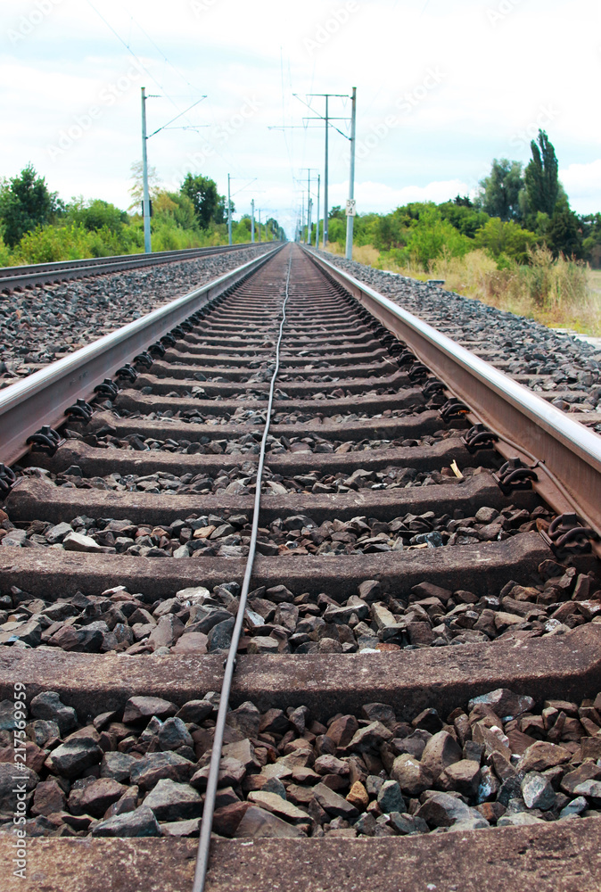 Fototapeta premium low angle view from a railroad track to the horizon