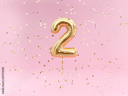 Two year birthday. Number 2 flying foil balloon and confetti. Two-year anniversary background.