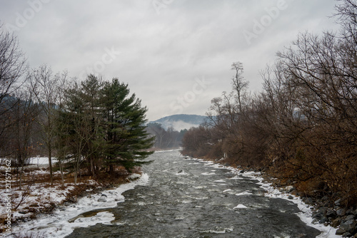 Winter river flowing with r...