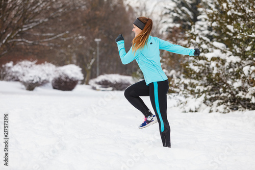 Running girl wearing sportswear, winter fitness