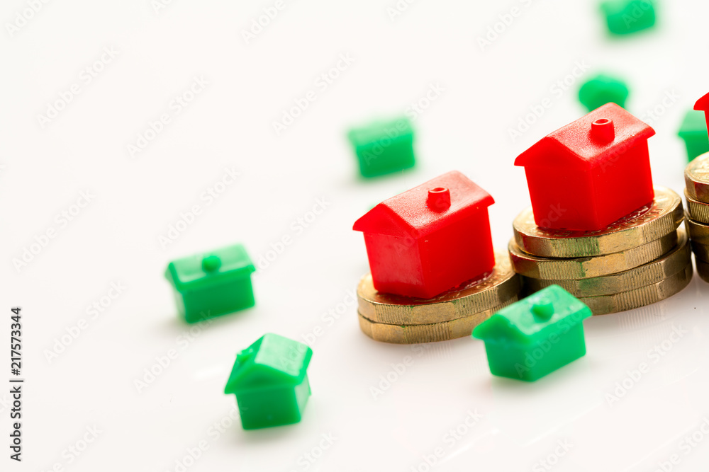 Housing estate concept with coins in studio Housing estate concept with coins in studio