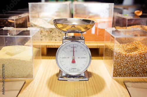Food weighing machine and different types of condiments in bulk in an organic store.