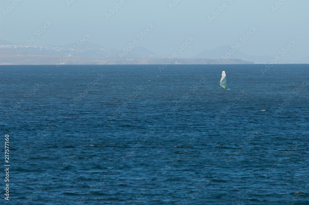 Windsurfer and island of Lanzarote (south) in the background. Majanicho. La Oliva. Fuerteventura. Canary Islands. Spain.