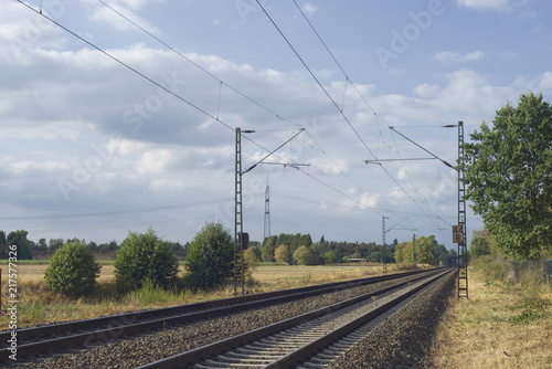 Railway tracks in a rural scene along with electricity posts in outskirt of Düsseldorf, Germany