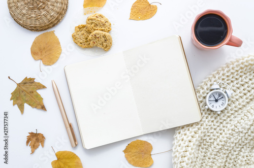 Autumn mockup with empty notebook, dry leaves, scarf and coffee. Flat lay, top view