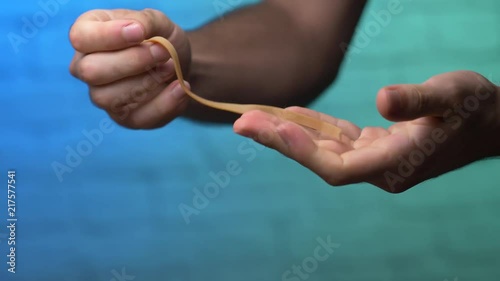 Stretching an elastic rubber band to its limit and breaking it. photo