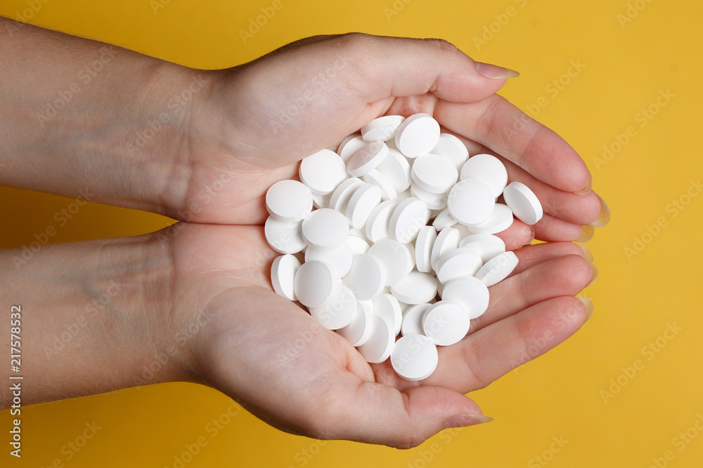 Woman hand with pills medicine tablets in her hands. Healthcare, medical supplements concept Woman hand with pills medicine tablets in her hands. Healthcare, medical supplements concept