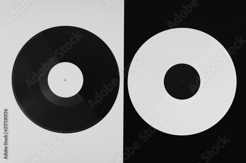 top view of a black and a white long play vinyl record on the black and white background