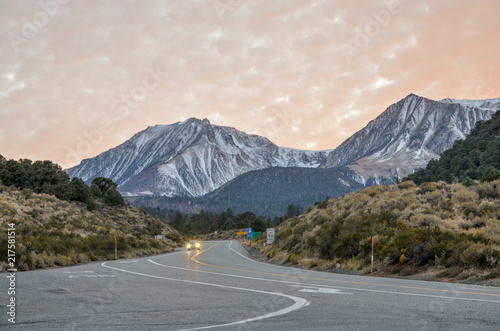 motor car going down Tioga Pass road at sunset Lee Vining county, California