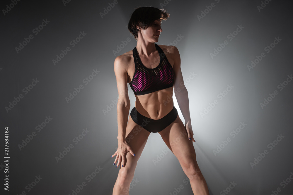 Woman on the dance floor. Female pole dancer dancing on a black background