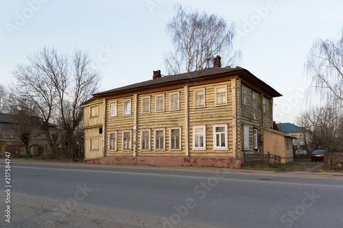 Old wooden two-storey house beside the road