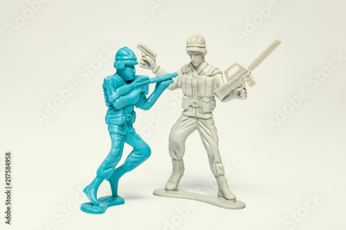 macro plastic toy soldier with gun taking prisoner the enemy soldier
