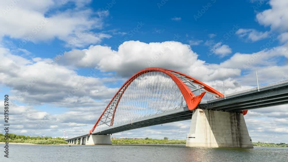 Clouds are running in the blue sky over the red bridge over the Ob river. Timlaps, Novosibirsk, Siberia.
Clouds are running in the blue sky over the red bridge over the Ob river. Timlaps, Novosibirsk, Siberia.
