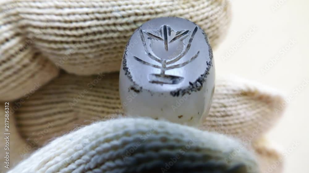 Ancient pendent seal made of stone with the image of flower or pomme grenade. Used to make impression on clay, paper or wax