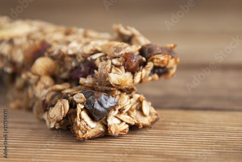 Healthy snack. Fitness. Dietary food. Cereal granola bars with nuts, dried fruits, bannana, honey and oat meal. Isolated.
