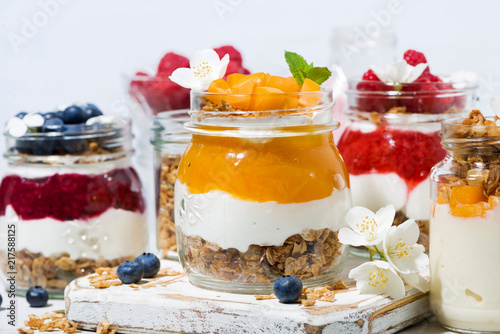desserts with muesli, berry puree and fruit in jars