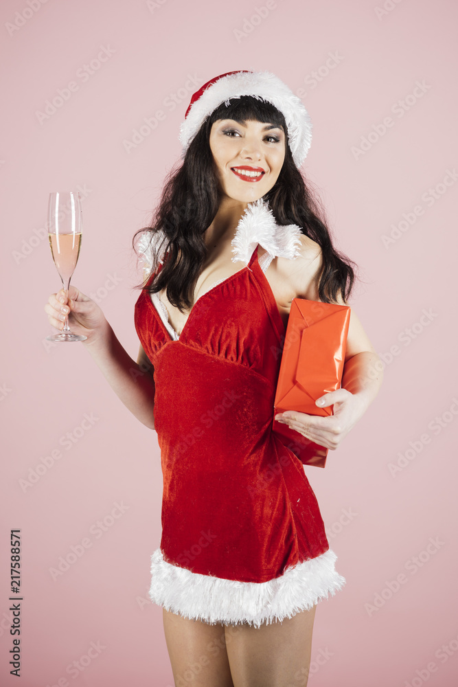 Woman celebrates christmas with glass of champagne. Woman celebrates christmas with glass of champagne.