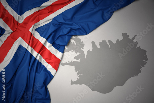 waving colorful national flag and map of iceland. photo