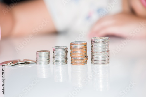  Girl putting coin, saving money and concept financial 