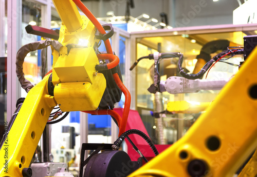 industrial line with yellow robots on sides, production and processing of metal parts, slective focus