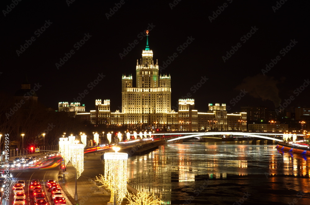 Fototapeta premium Christmas illumination on Moskvoretskaya embankment. Night view of high-rise building on Kotelnicheskaya embankment, Moscow, Russia
