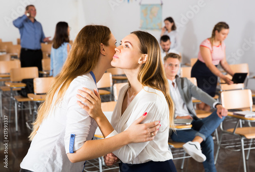 Two girls greeting each other with kiss