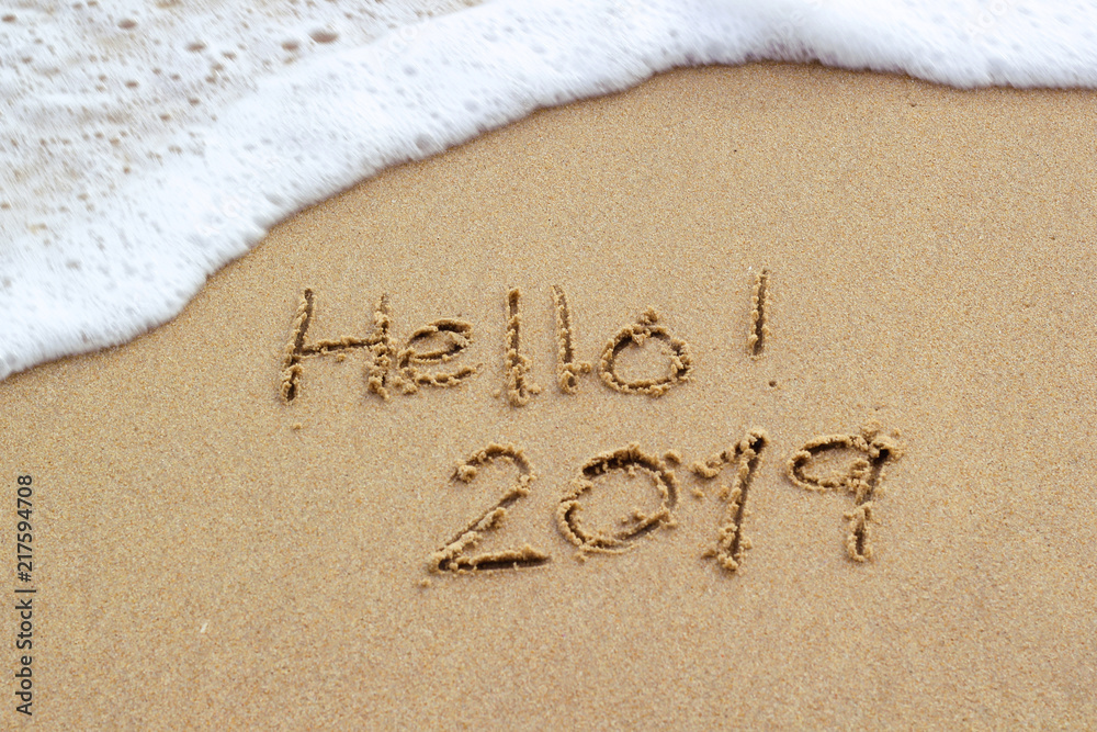 Fototapeta premium New Year 2019 sign in tropical beach sand with turquoise ocean