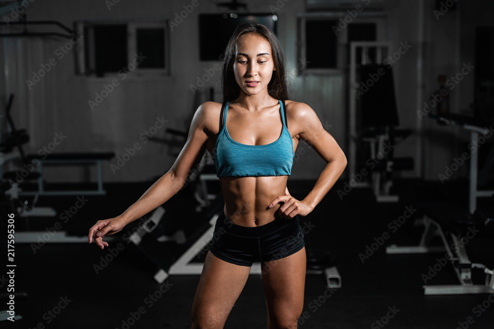 fitness girl exercising with barbell, woman posing in gym