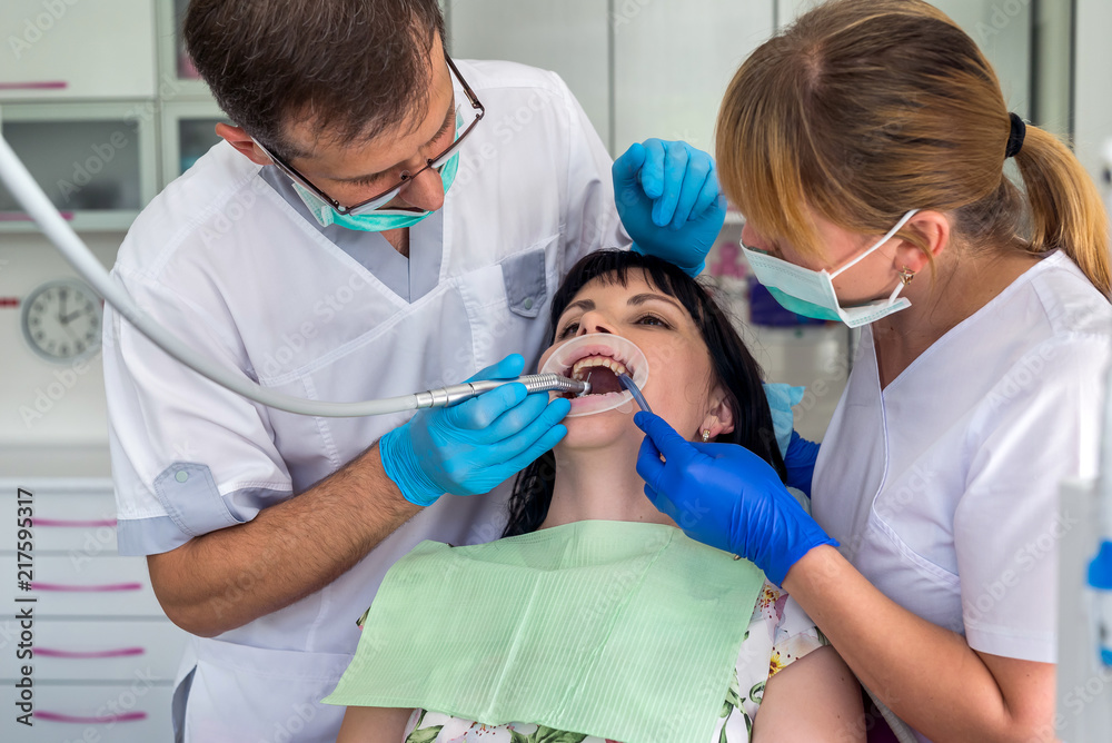 Doctor and nurse working with patient in dentistry Doctor and nurse working with patient in dentistry
