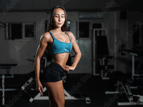 fitness girl exercising with barbell, woman posing in gym