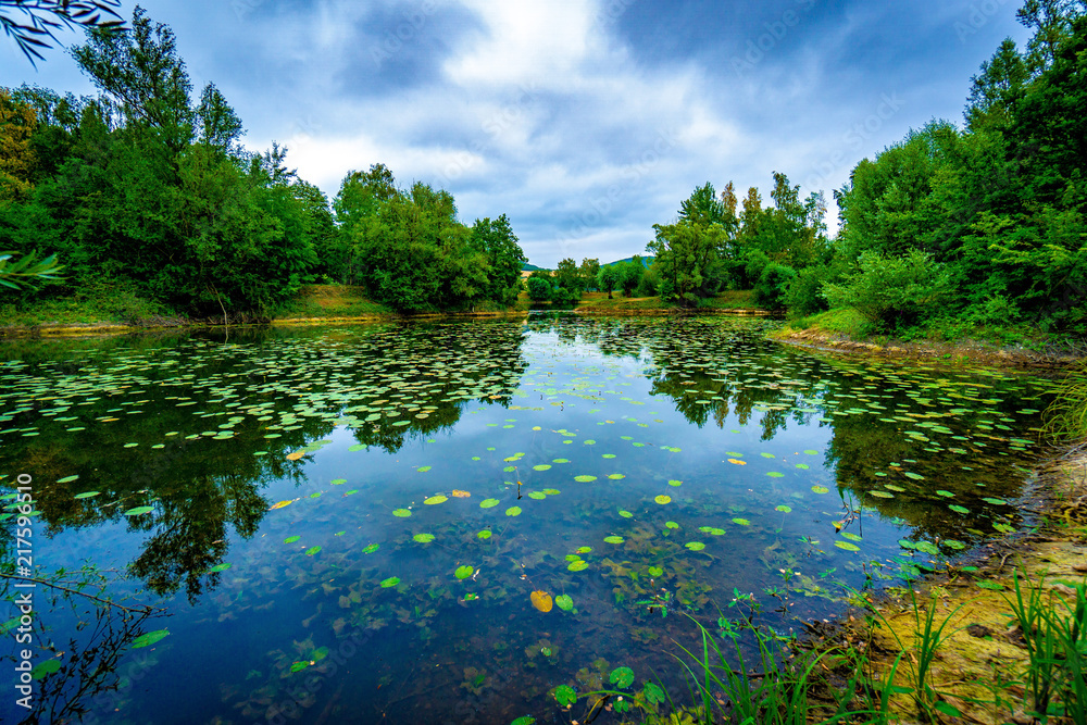 restless sky above calm lake