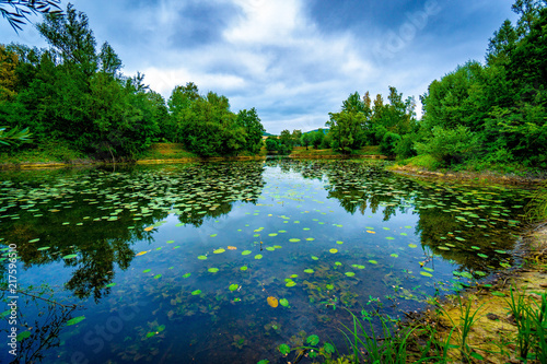 restless sky above calm lake
