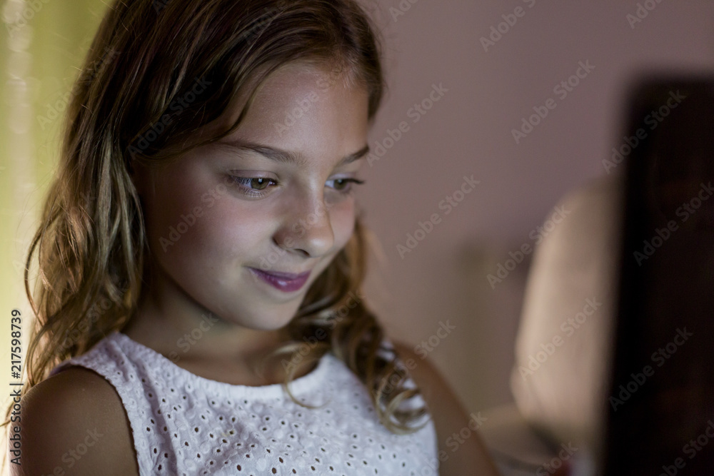 young kid girl using a tablet at home. technology concept. Family lifestyle indoors young kid girl using a tablet at home. technology concept. Family lifestyle indoors