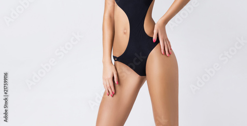 Young, fit and beautiful girl in sporty swimsuit. Sport, diet, health and beauty concept.