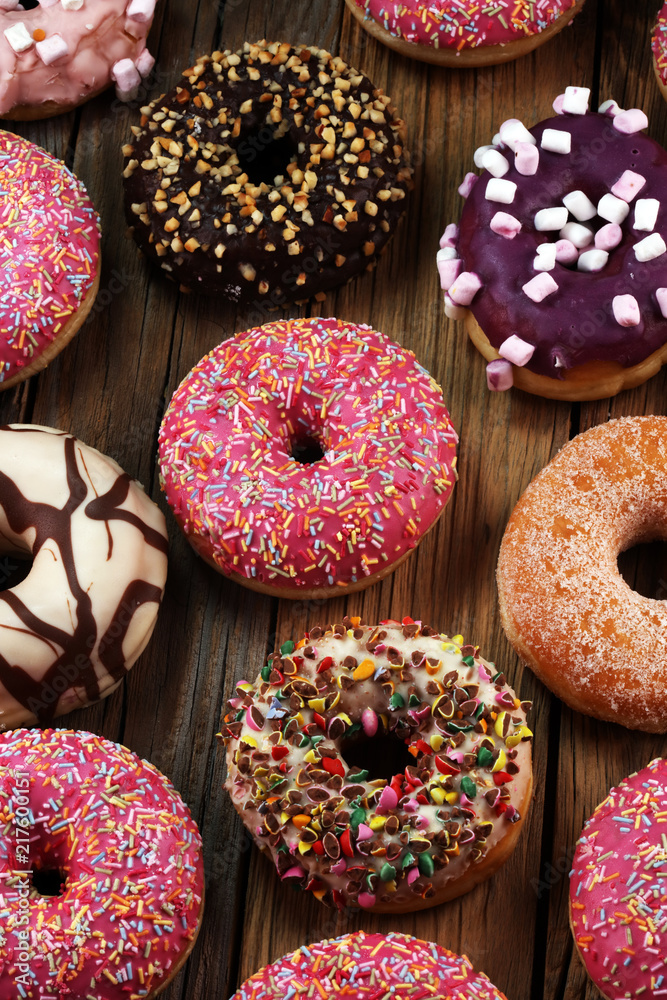 assorted donuts with chocolate frosted, pink glazed and sprinkles donuts assorted donuts with chocolate frosted, pink glazed and sprinkles donuts