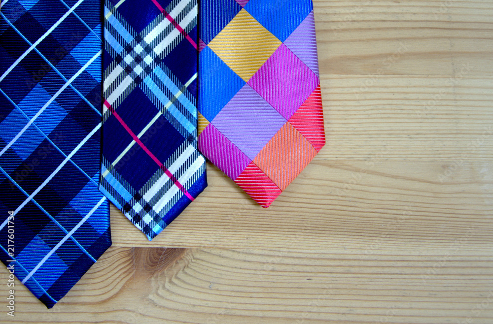Obraz premium Fashion ties on the background of wooden boards. background and concept.