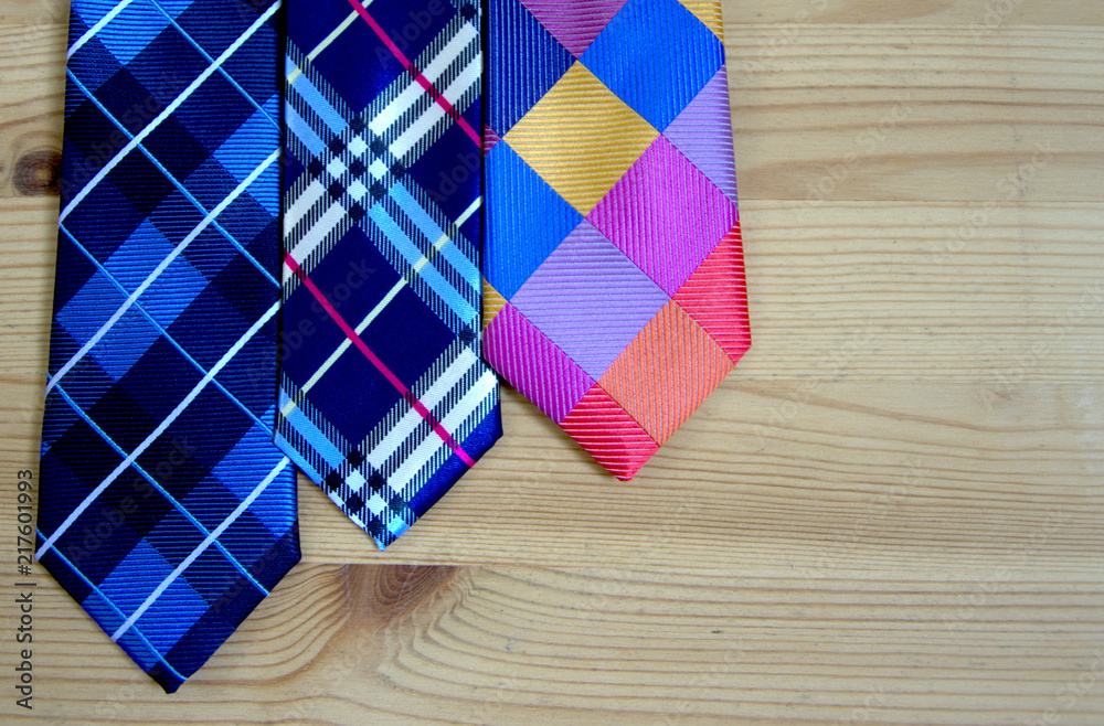 Obraz premium Fashion ties on the background of wooden boards. background and concept.