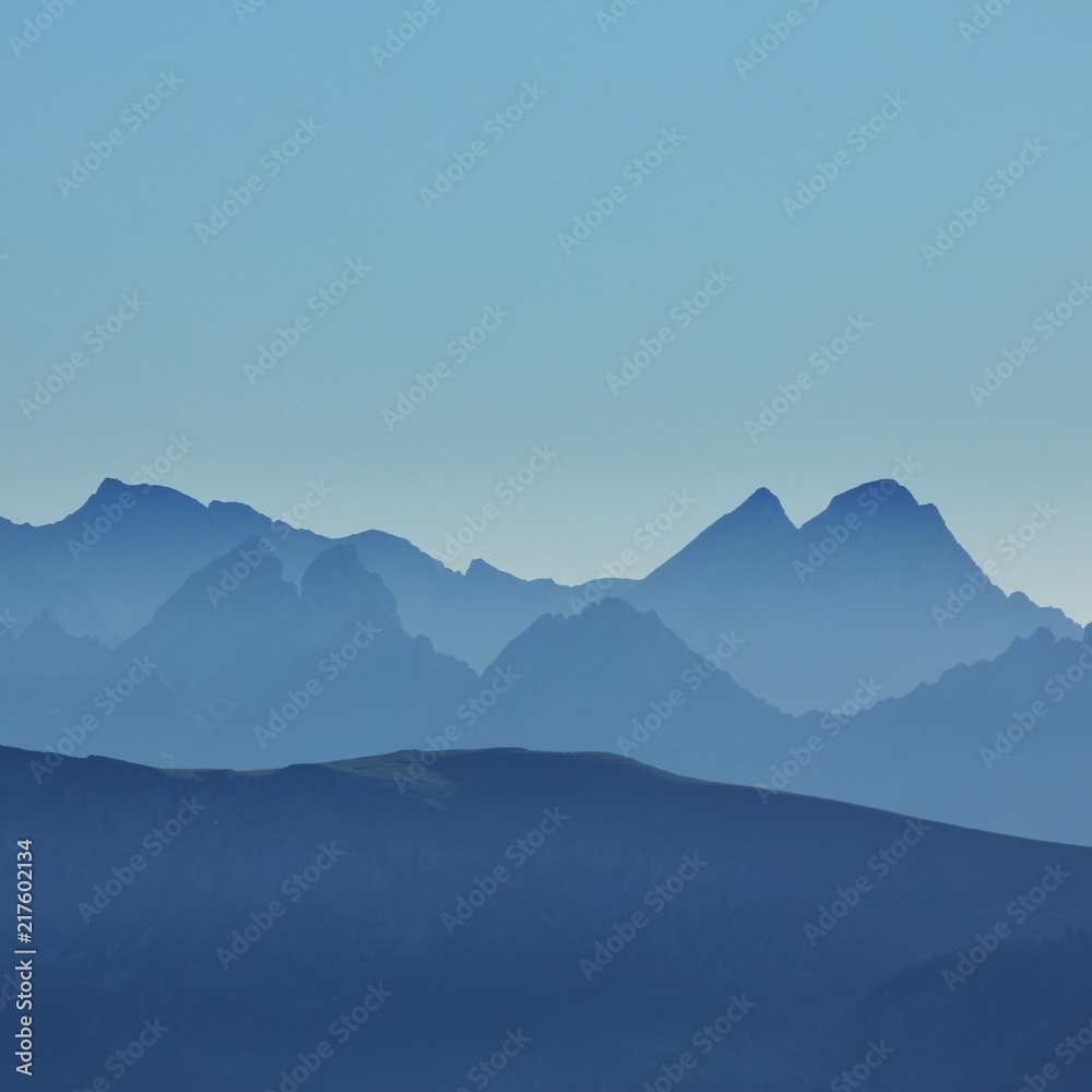 Silhouettes of mountain peaks seen from Mount Niesen. Bernese Oberland.
