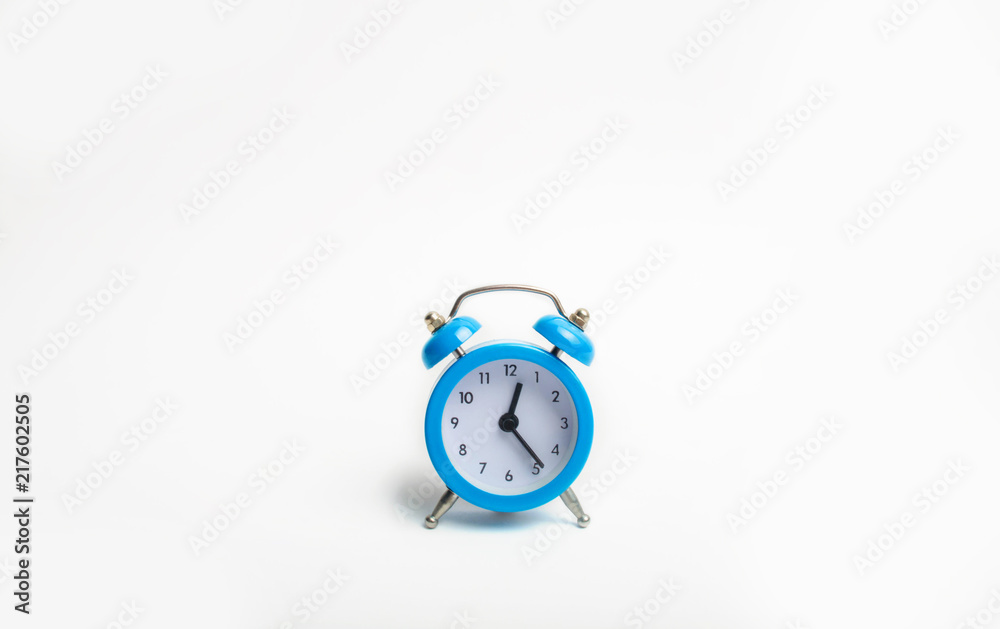 blue alarm clock on white background indicates the beginning of the first. time management. concept of the flow of time, time to action. minimalist style. Time is money. blue alarm clock on white background indicates the beginning of the first. time management. concept of the flow of time, time to action. minimalist style. Time is money.