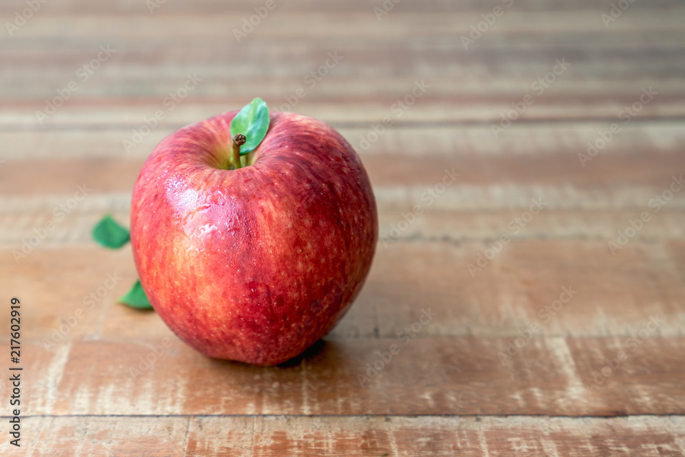 One fresh apple on wooden rustic background One fresh apple on wooden rustic background