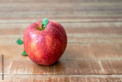 One fresh apple on wooden rustic background