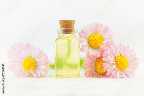 Essence of flowers on table in beautiful glass jar