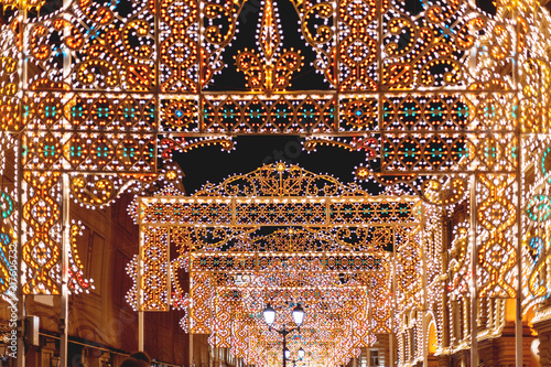 Streets of Moscow decorated for New Year and Christmas celebration. Buildings with light bulbs. Russia.