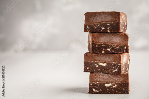 Stack of chocolate fudge bars on white background. Raw vegan dessrt. photo