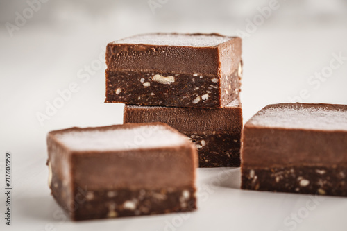 Chocolate fudge bars on white background. Raw vegan dessrt.
