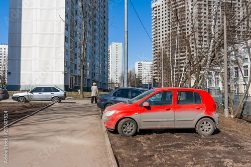 Drivers parked their cars on the lawn. People are breaking parking rules. Moscow, Russia.